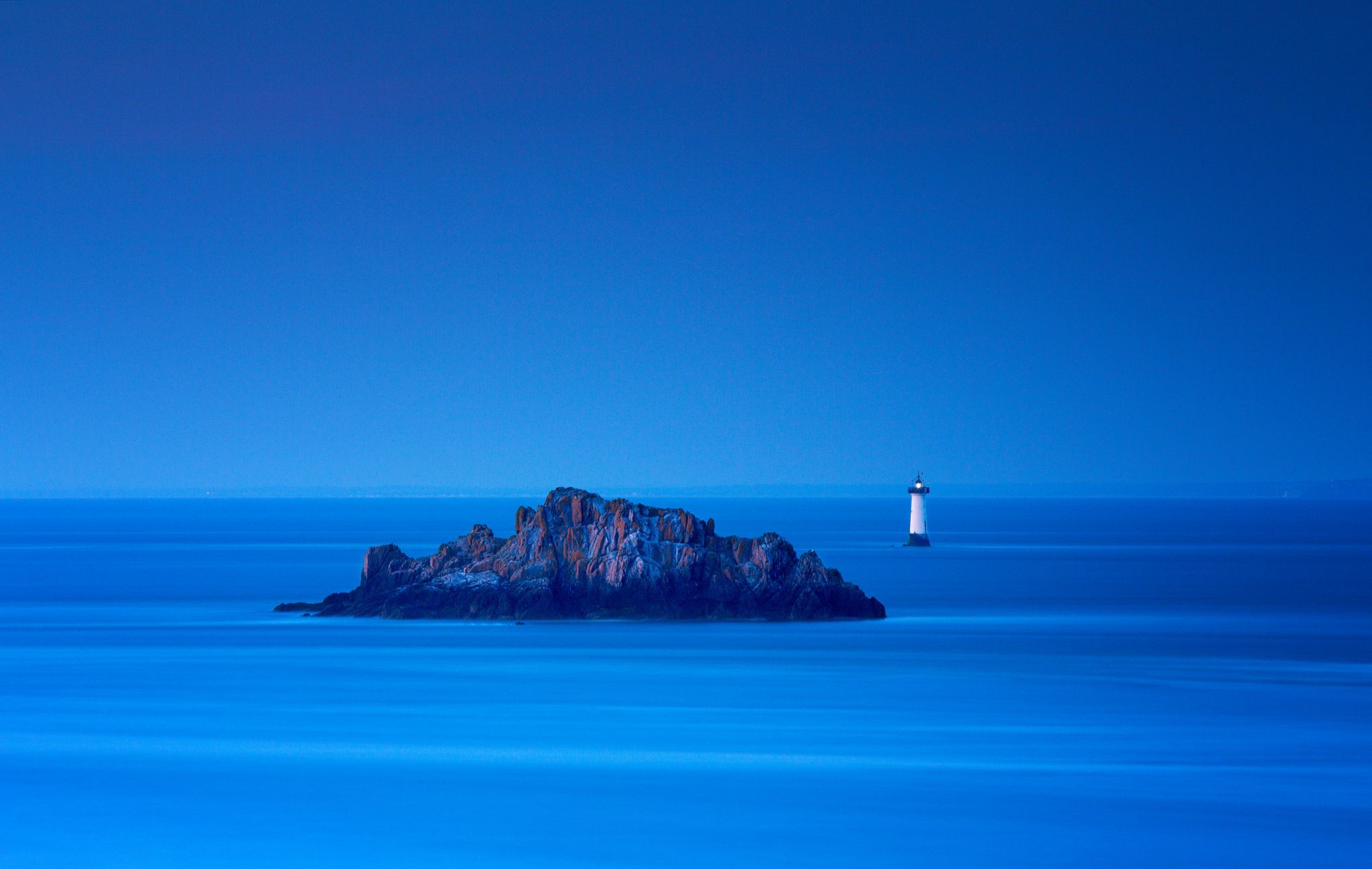 Last light on lighthouse, France