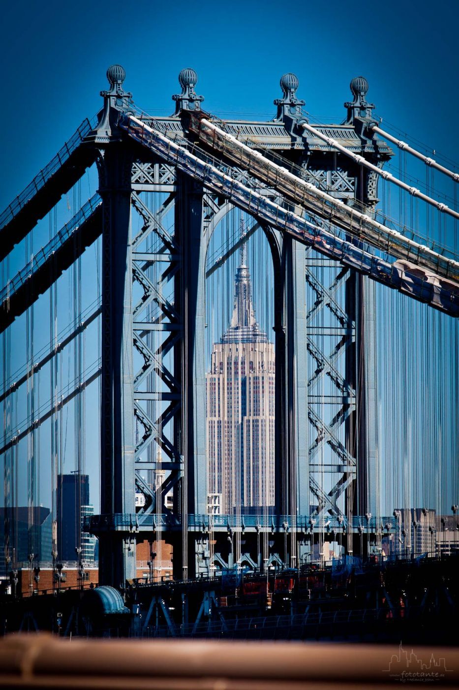 Empire State Building view through Manhattan Bridge, USA