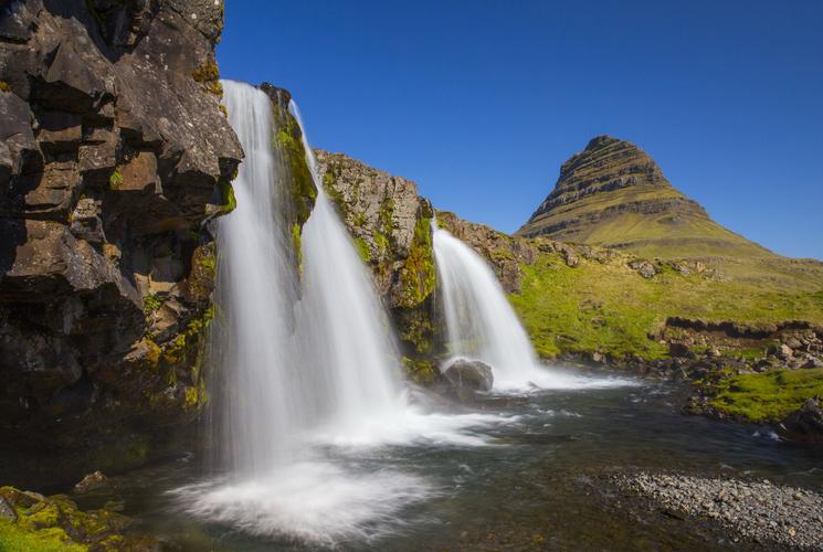 Kirkjufellsfoss waterfall and Kirkjufell mountain in Iceland