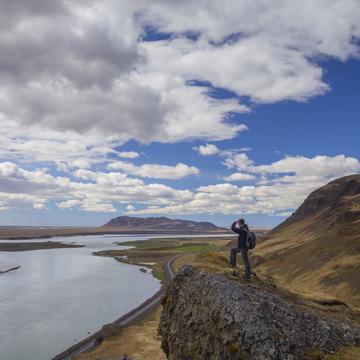 Traveler on peak of mountain in Asolfsstadhir, Iceland, Iceland