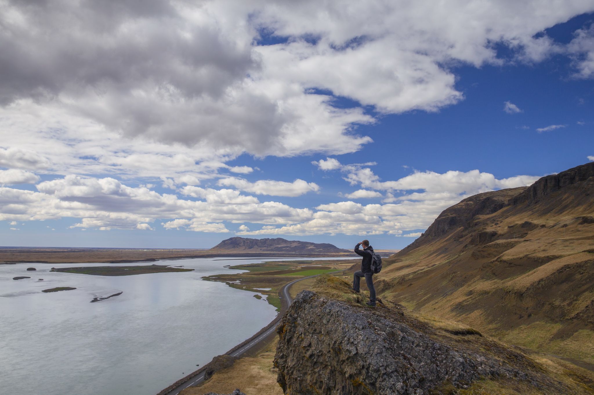 Traveler on peak of mountain in Asolfsstadhir, Iceland, Iceland