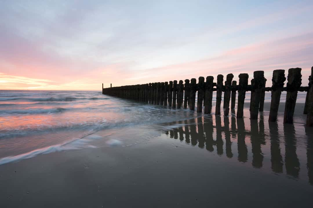 A longer exposure (+2 stops) for the wooden stakes and smoother waves.