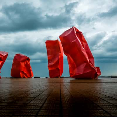 Red 'Rock Strangers' Sculpture at harbour's mouth in Ostend, Belgium