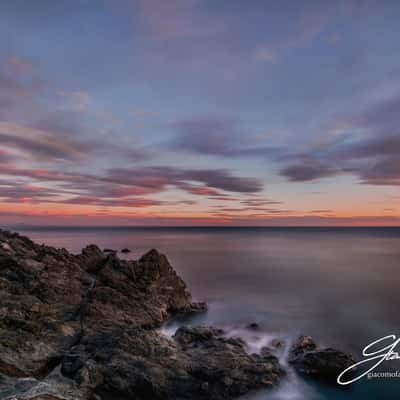 Black rocks sunset, Italy