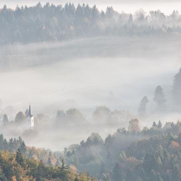 Village church in fog, Slovenia