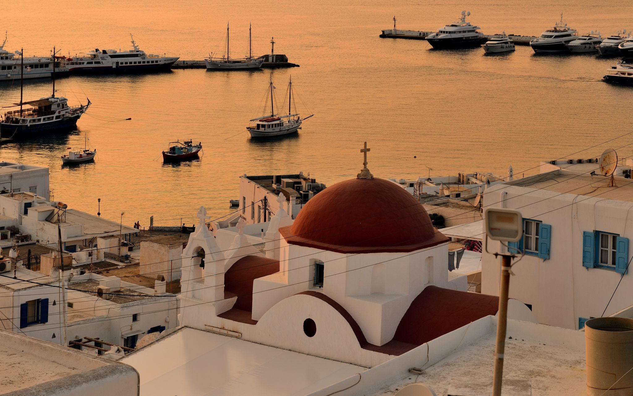 Red dome at sunset in Mykonos old harbour, Greece