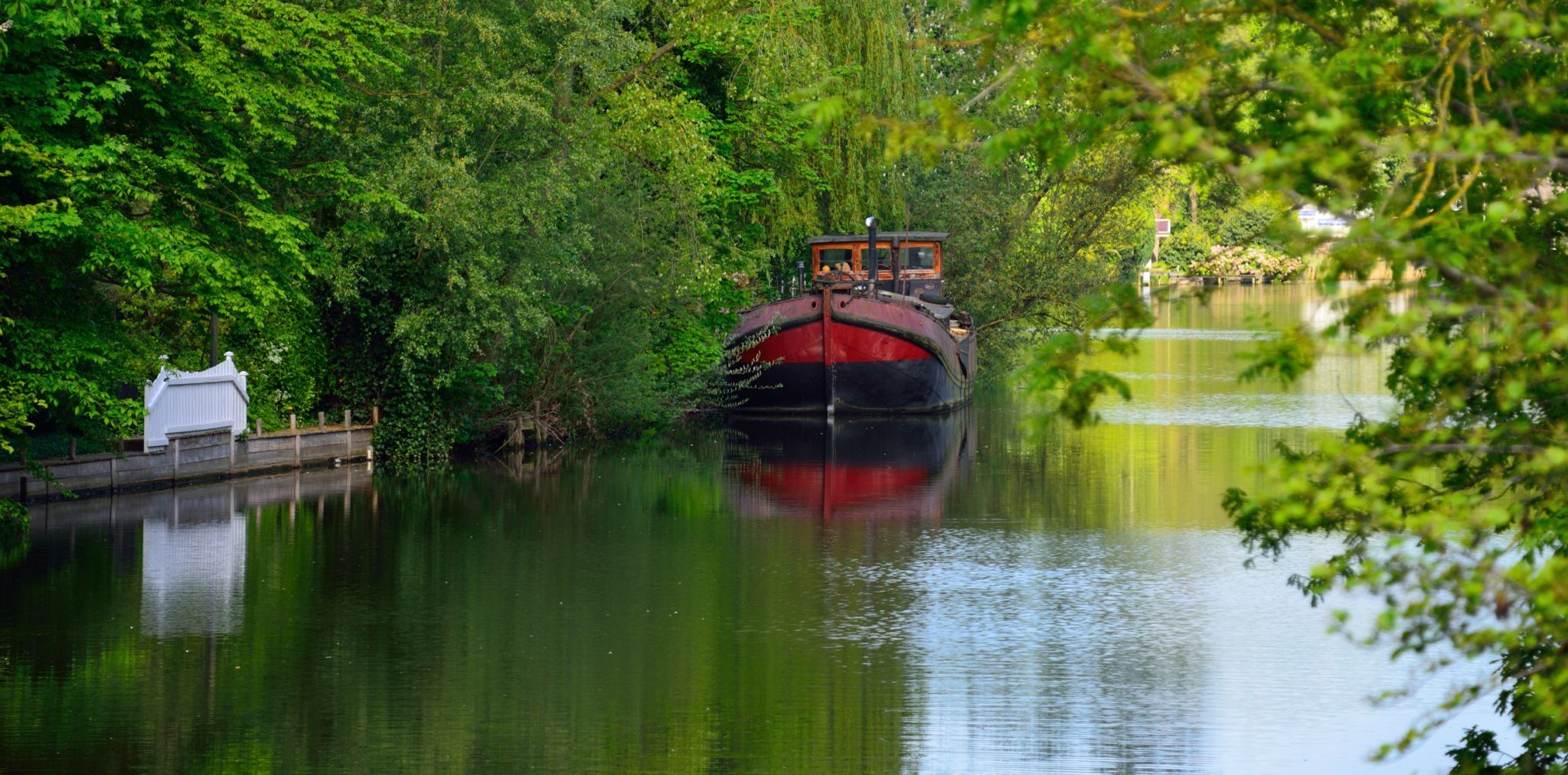 The red boat on the Vecht river, Breukelen, Netherlands