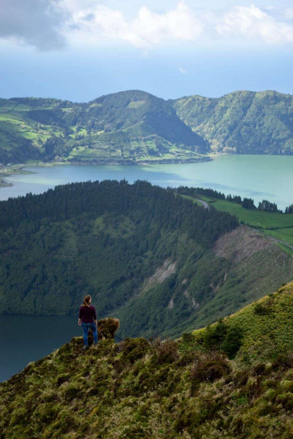 This is a good choice for the framing of the image because she is standing at a cliff and the background behind her is blurred a bit, which gives the photo a better dimension.