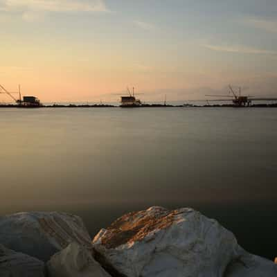 Fishermen's huts on Marina di Pisa at sunset, Italy