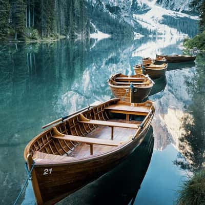 Boats in a bay of the Braies Lake, Dolomites, Italy