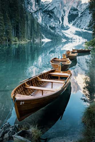 Boats in a bay of the Braies Lake, Dolomites