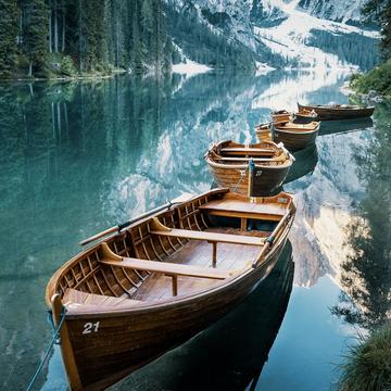 Boats in a bay of the Braies Lake, Dolomites, Italy
