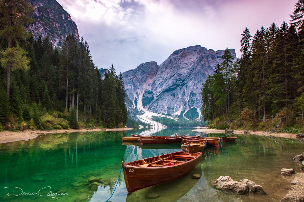 Boats in a bay of the Braies Lake, Dolomites, Italy