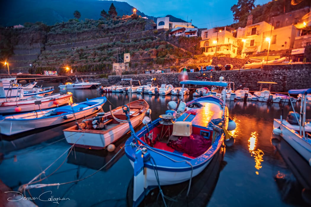 Fishing boats with old storage behind Malfa Salina, Italy