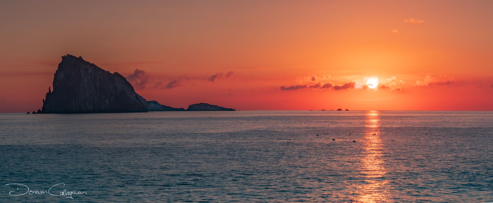 Panarea the sun is rising over the island of Dattilo, Italy