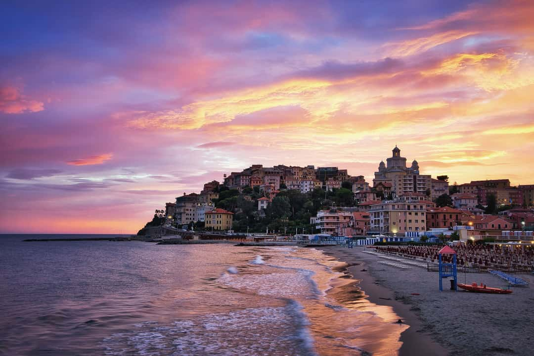 The final result after doing some last improvements within Photoshop and using the Nik filters. This one is based on the Luminar edit because I really liked the sky in this version. It was taken during sunset at the pier of Imperia, which has a beautiful old town at the Italian Riviera.