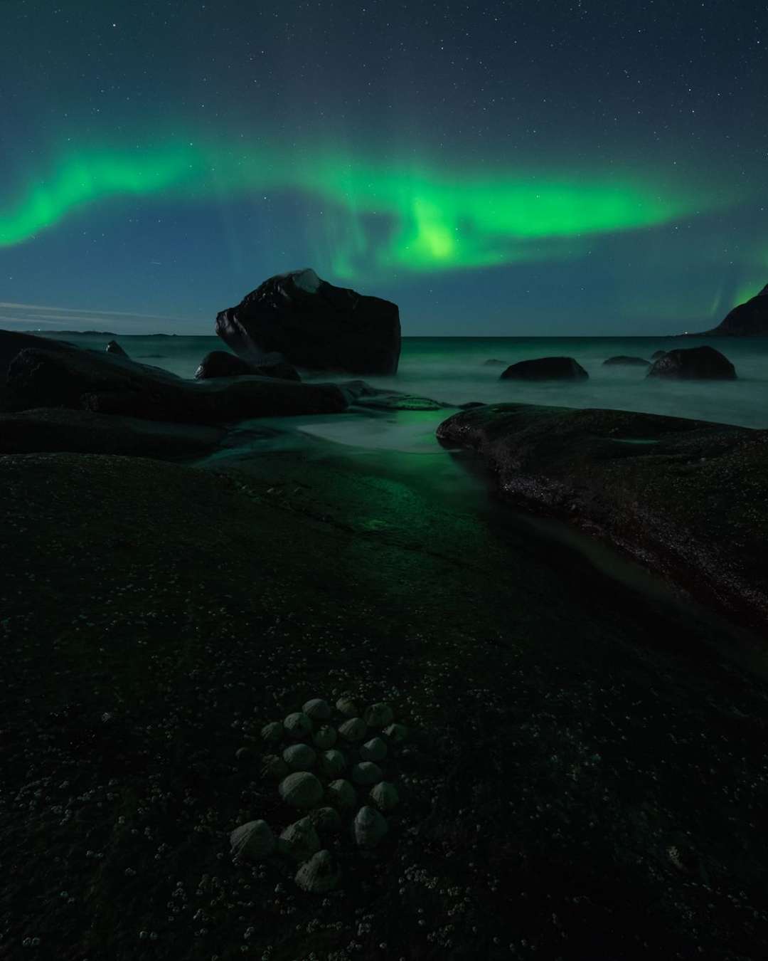 The aurora and the light on the foreground shells in step two look a bit different from the previous step because it’s a focus stack. The sky is an exposure taken a bit earlier and the foreground is taken later, allowing the moon to illuminate the shells more and have everything in sharp focus. Even at night.