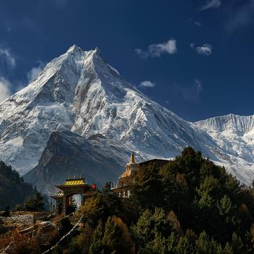 Buddhist temple in Lho and east face of Manaslu, Nepal
