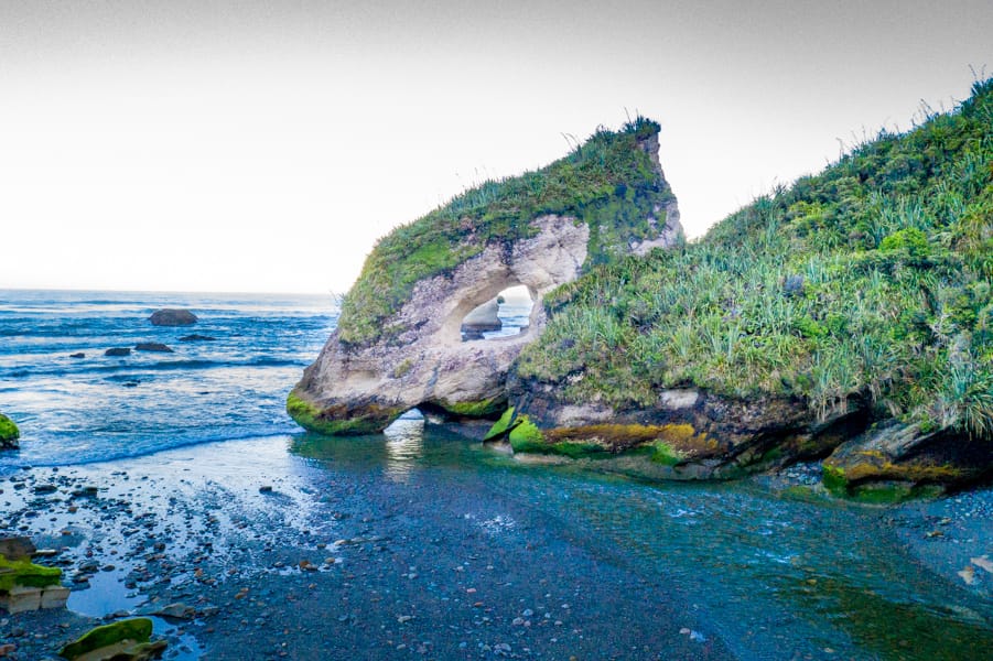 Ocean Stack with a hole Rapahoe South Island, New Zealand
