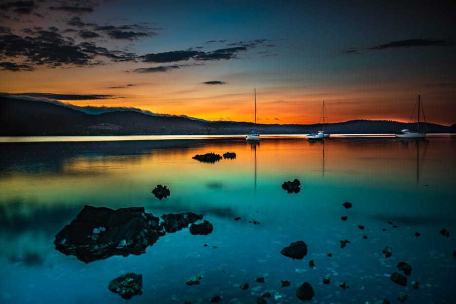Three sailing boats at sunrise Cygnet Tasmania, Australia