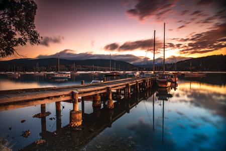 Wharf and sailing boat sunrise Cygnet Tasmania