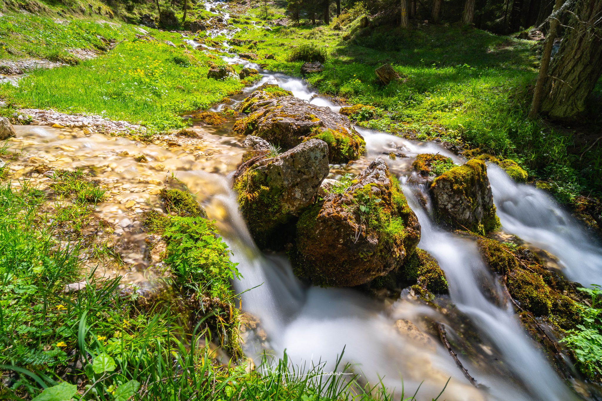 Chapel and waterfalls in Langental, Wolkenstein, Italy