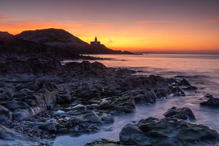 The Mumbles Lighthouse at sunrise Wales