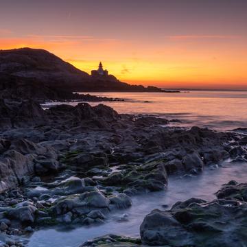 The Mumbles Lighthouse at sunrise Wales, United Kingdom