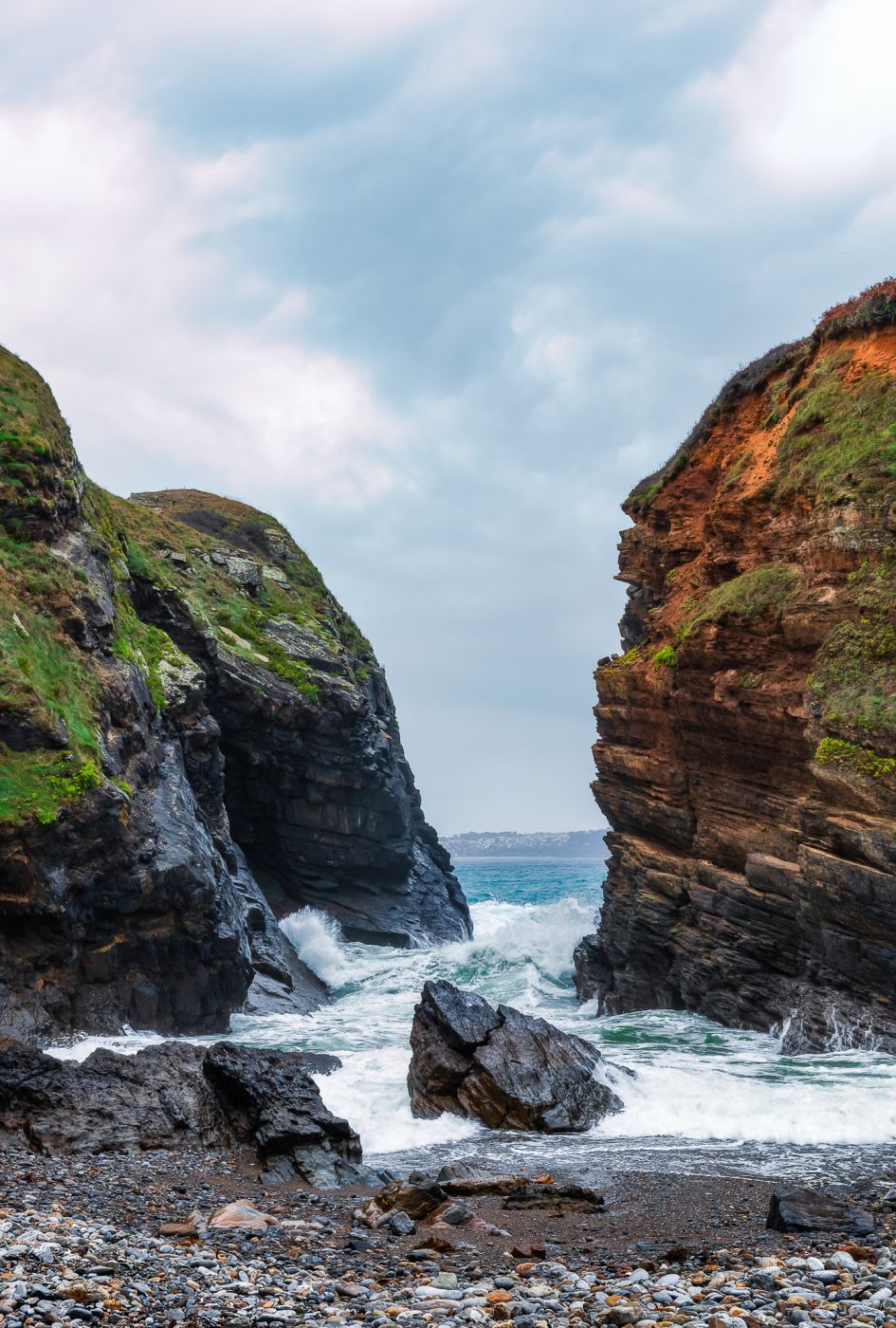 The incoming tide reaches a secluded pebble beach, France