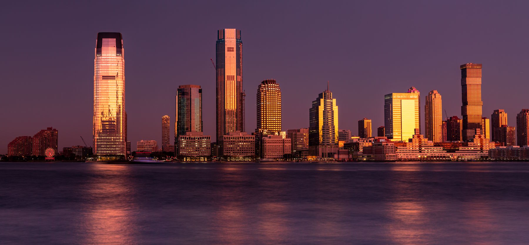 Jersey City reflection sunrise from Lower Manhattan, New York City, USA
