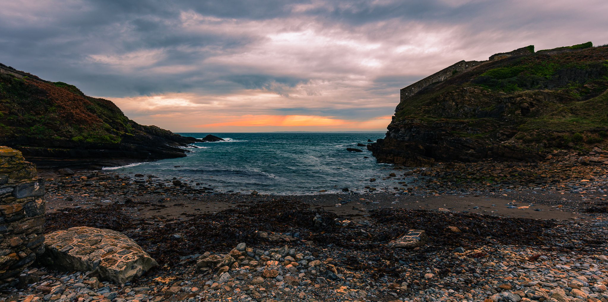 Secluded little cove at sunset, France