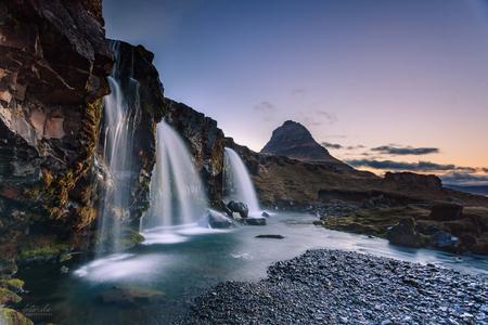 Kirkjufellsfoss waterfall and Kirkjufell mountain in Iceland