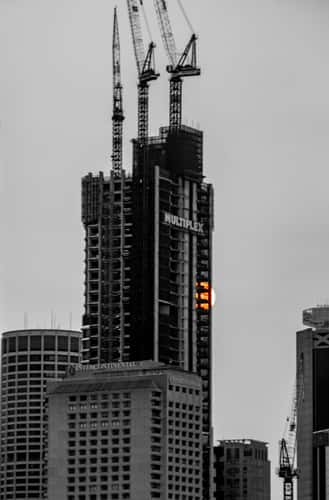 Sun disappearing behind a building Sydney harbour
