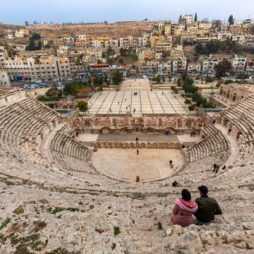 A young couple enjoying the view at the Roman Theatre, Jordan