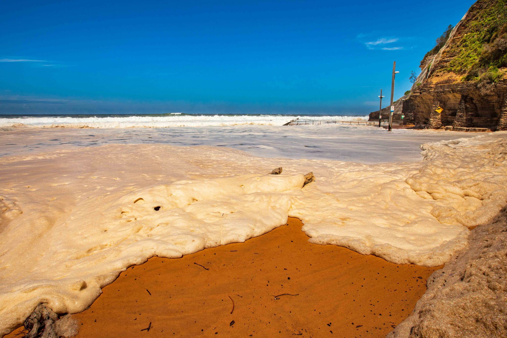 Bilgola Beach sea foam marching New South Wales, Australia