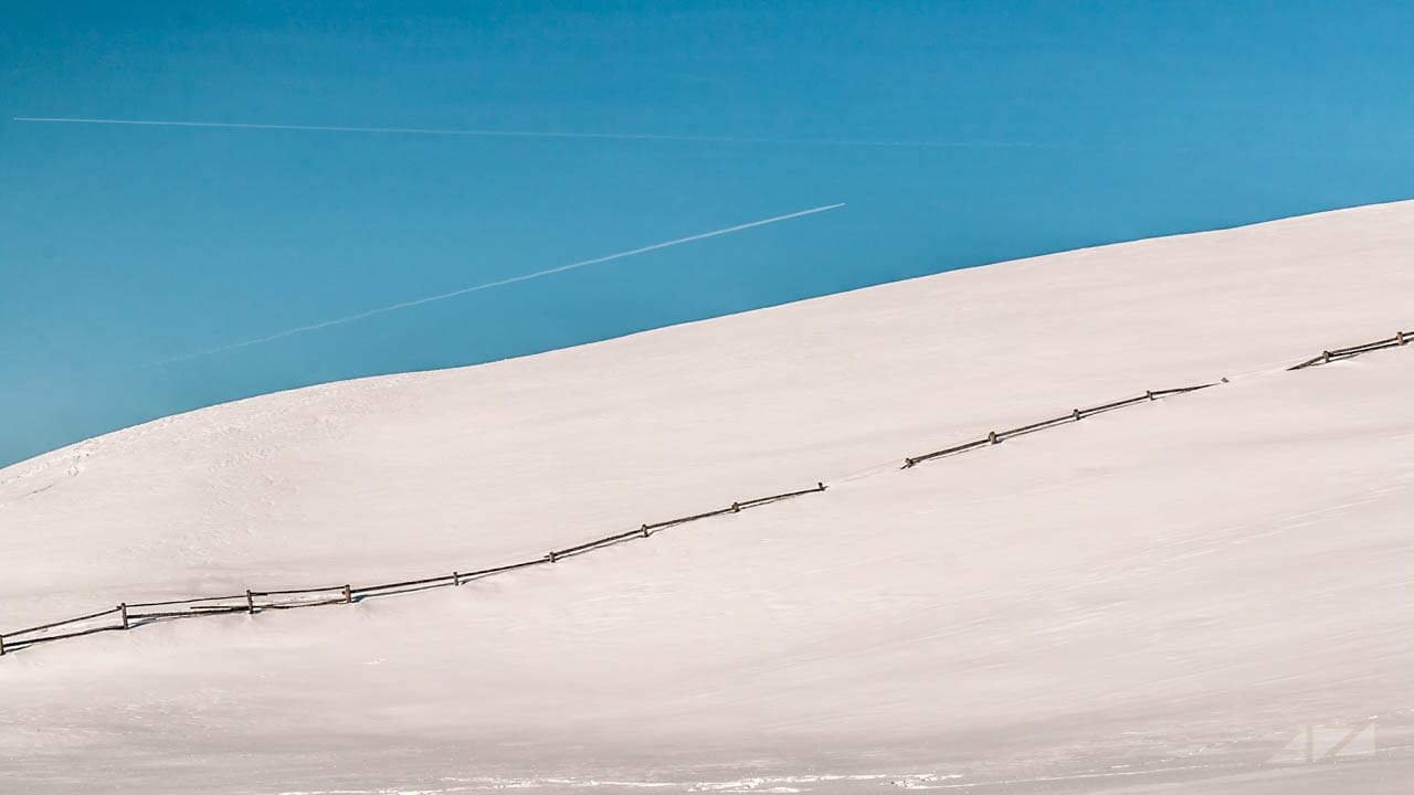 Railing and sky rows over  Rodenecker Alm, Italy