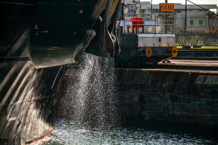 Ship discharing water and the tow train Panama Canal