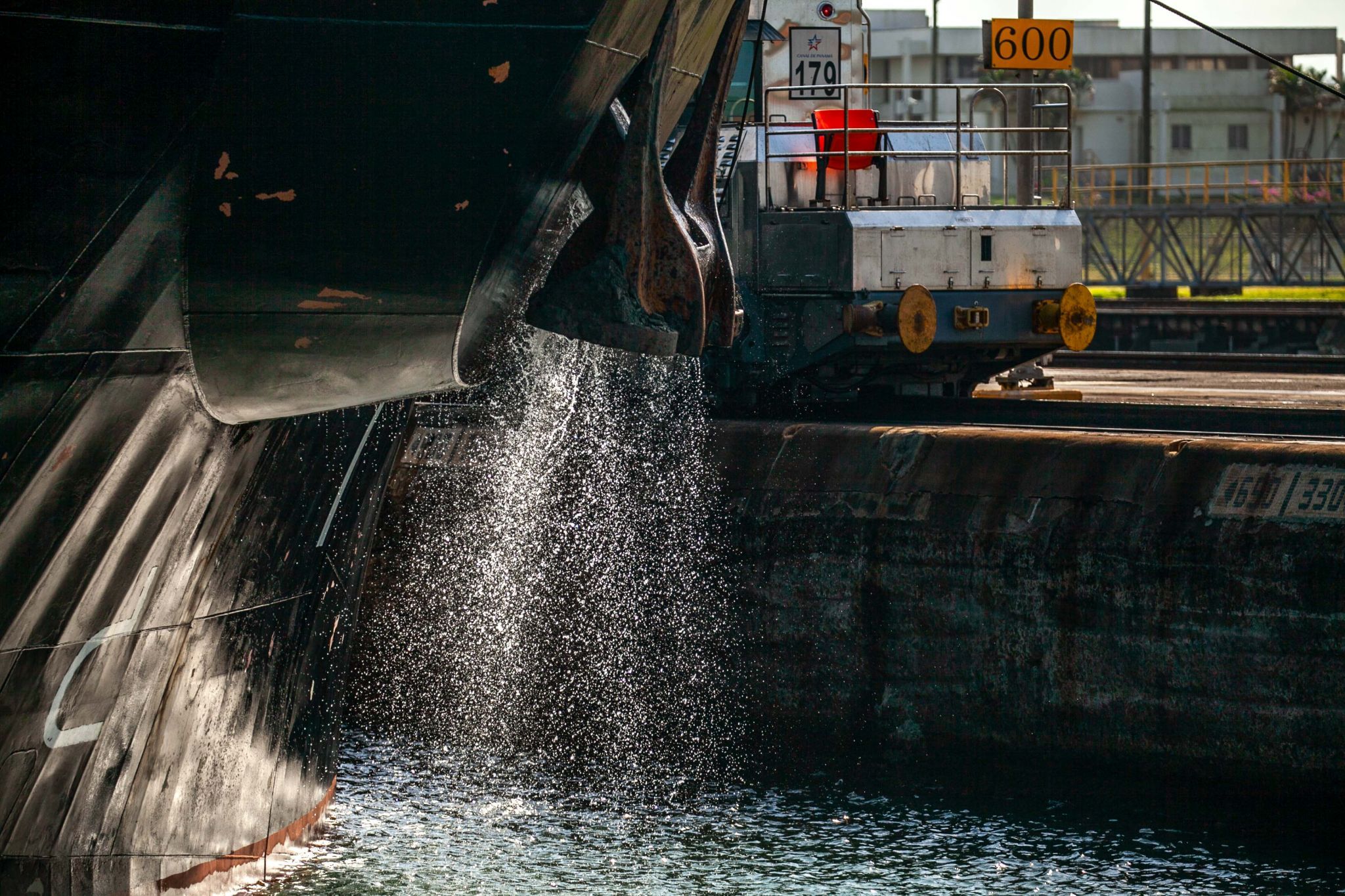 Ship discharing water and the tow train Panama Canal, Panama