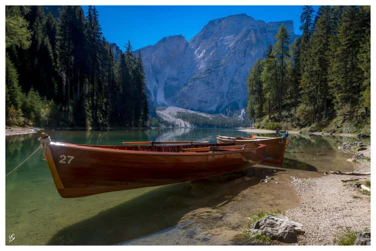 Boats in a bay of the Braies Lake, Dolomites