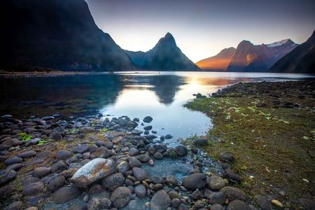 Milford Sound sunset with foreground  rock South Island