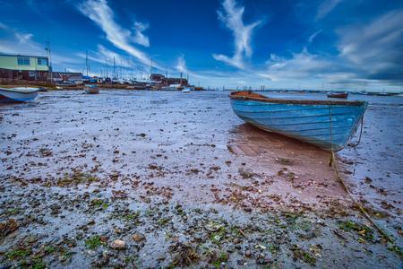 Blue Boat on mudflats Mersea island England