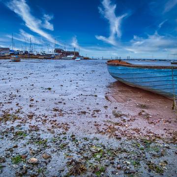 Blue Boat on mudflats Mersea island England, United Kingdom