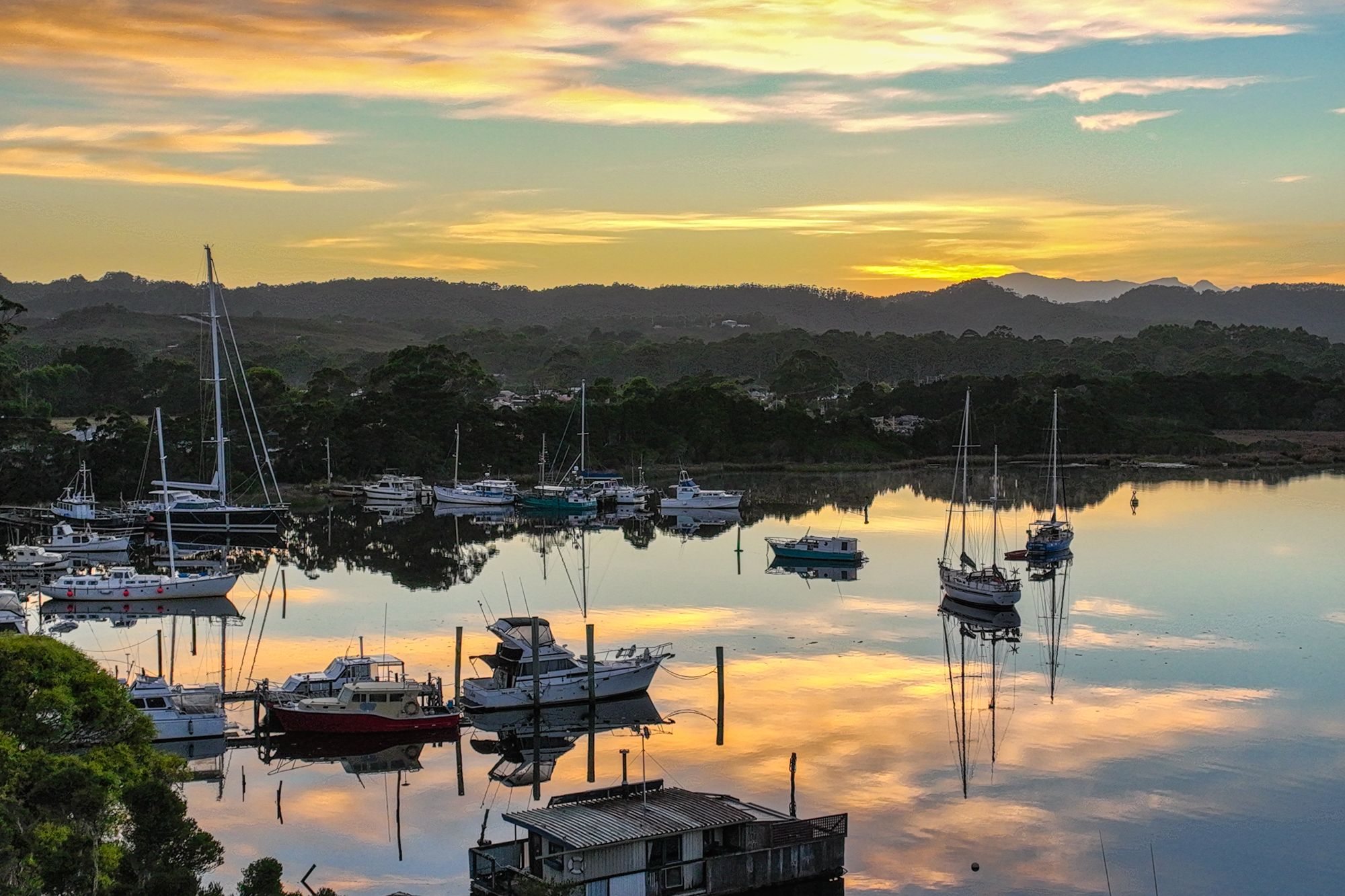 Drone shot sunrise Morse Bay, Strahan, Tasmania, Australia