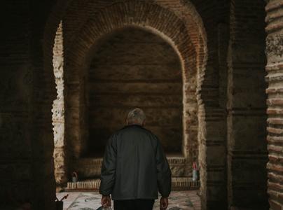 Old man walking through historical place