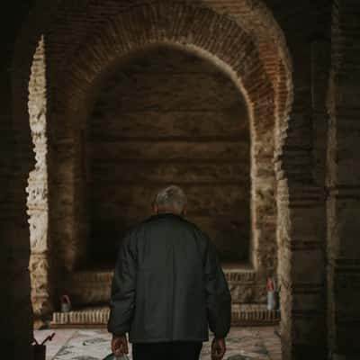 Old man walking through historical place, Morocco