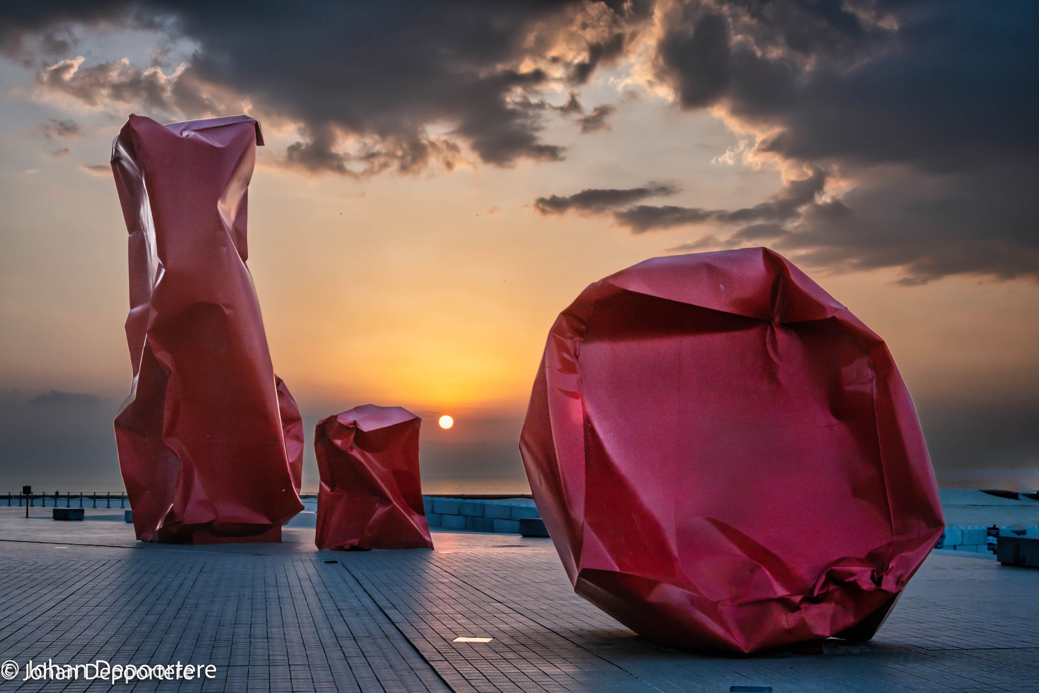 Red 'Rock Strangers' Sculpture at harbour's mouth in Ostend, Belgium