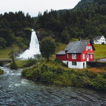 Steinsdalsfossen and red cabin, Norway