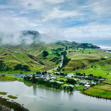 Cloud lifting town of Awakino, North Island, New Zealand