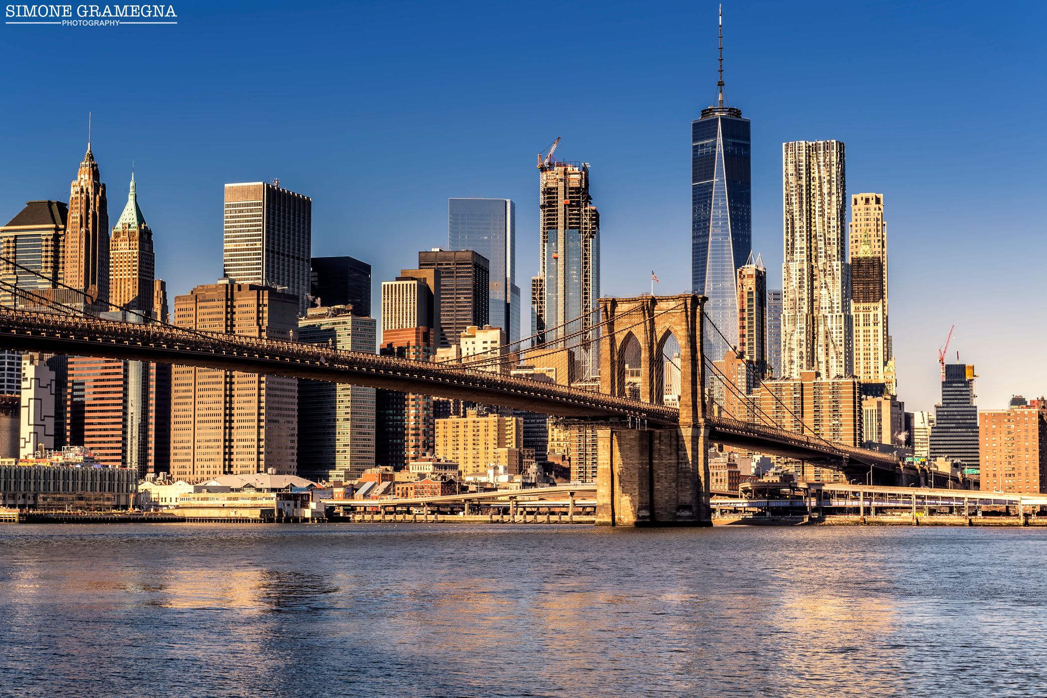 Brooklyn Bridge skyline from Pebble Beach, New York City, USA