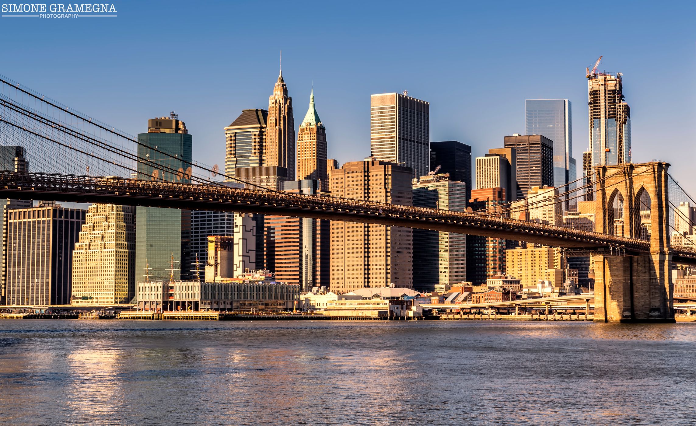 Brooklyn Bridge skyline from Pebble Beach, New York City, USA